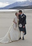 Bride and groom on beach at Ardverikie Estate