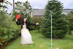 Bride and groom play swingball at wedding reception