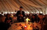 Magician does tricks in yurt at wedding reception