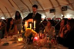 Magician does tricks in yurt at wedding reception